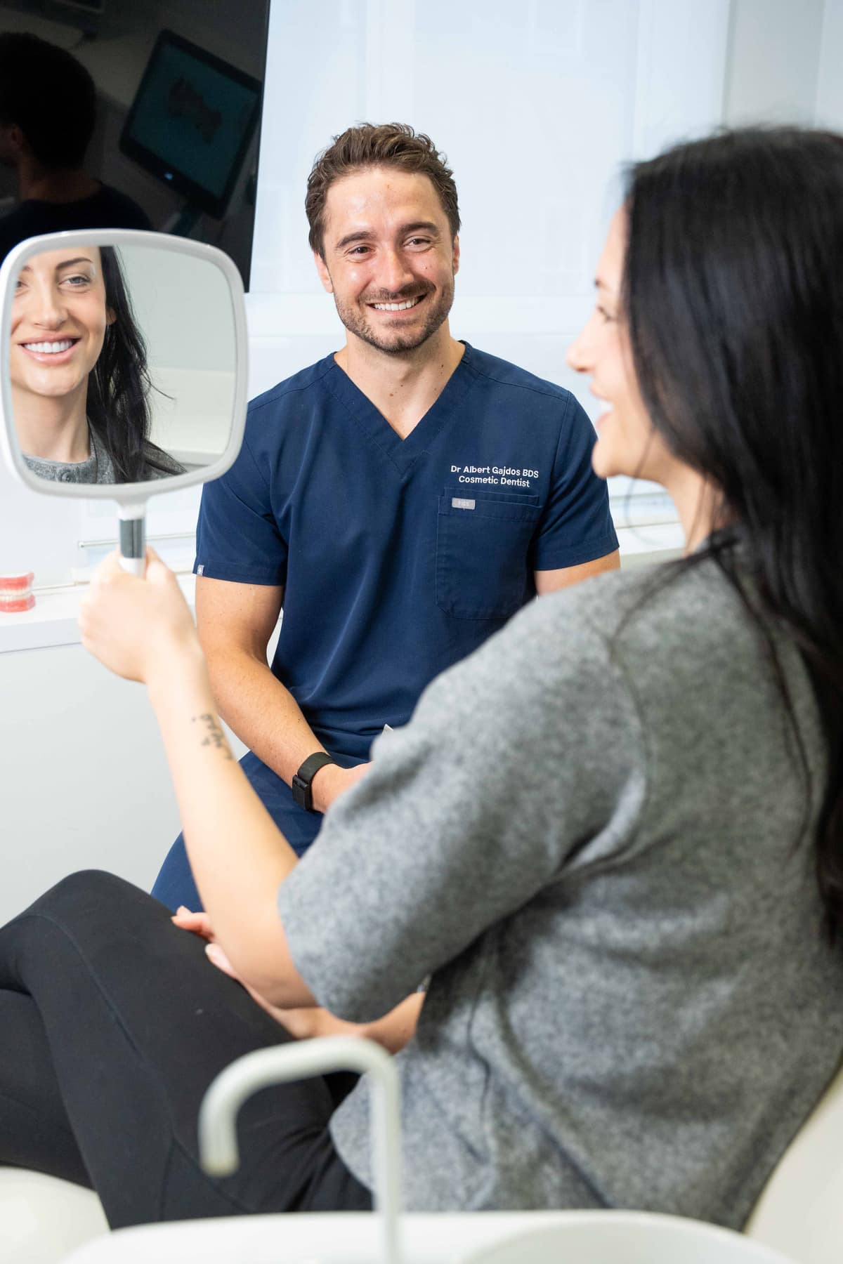 A patient seeing her trial smile with Dr. Albert Gajdos in Windsor